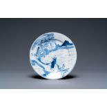 A Chinese blue and white plate with two men in a landscape, Kangxi