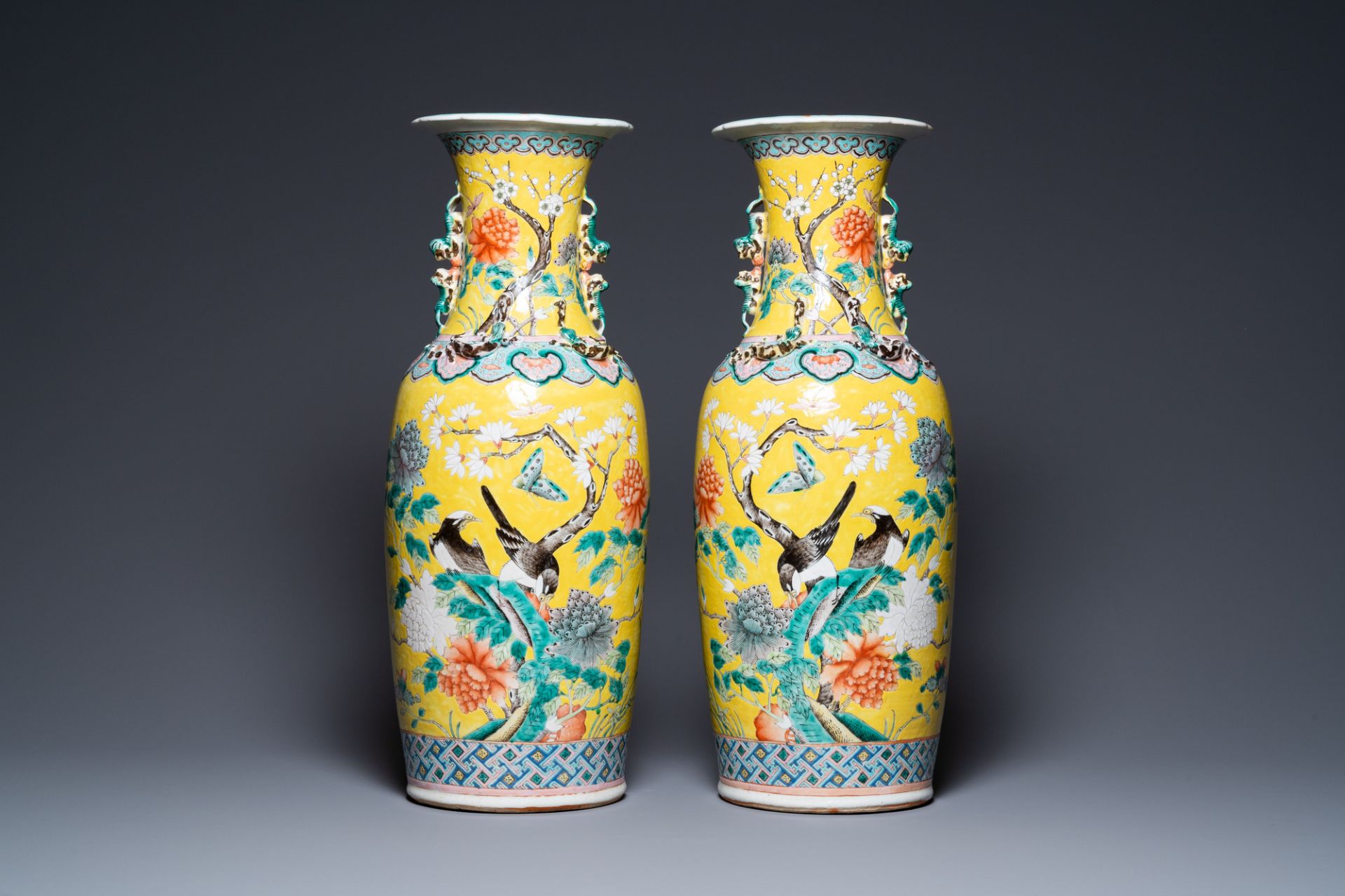 A pair of Chinese yellow-ground famille rose vases, 19th C.