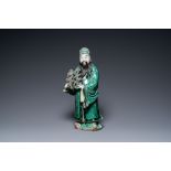 A Chinese verte biscuit figure of an immortal, 19th C.