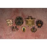 Seven partly gilt polychrome wood carvings of coats of arms, 17th C. and later