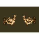 A pair of gilt wooden wall appliques with crowned cherubs, 18th C.