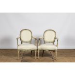 A pair of French white- and green-painted wooden armchairs, 19th C.