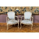 A pair of French Louis XV style patinated wooden armchairs, 20th C.