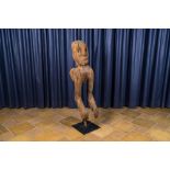 An anthropomorphic wooden sculpture mounted on a metal base, 20th C.