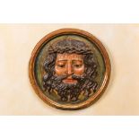 A polychrome wooden 'Christ with the crown of thorns' medallion, probably 17th C.