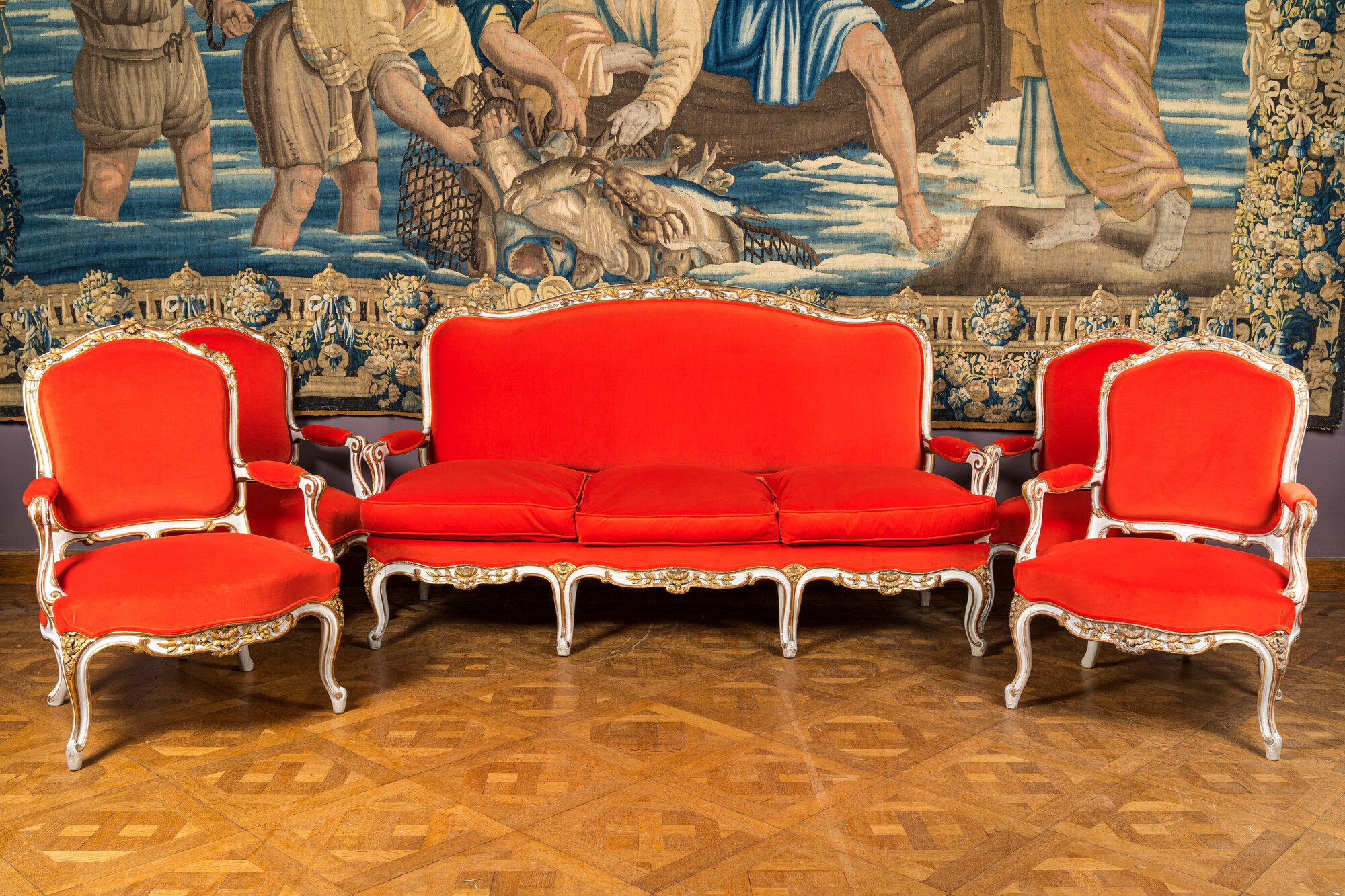 A partly gilt wooden sofa and four armchairs with red velvet upholstery, 18/19th C.