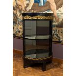 A gilt copper-mounted ebonised demi-lune bar cabinet with mirror back, 19th C.