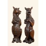 Two oak sculptures of mythical creatures with a shield, 19th C.