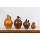 Four various stoneware jugs, incl. two bellarmine jugs and one with a gilt bronze chain mount, Raere