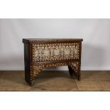 A Syrian mother-of-pearl-inlaid wooden bridal chest on stand, 19th C.