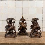 Three 'Black Forest' wooden sculptures depicting birds under foliage, one of which mounted as a lamp