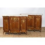 A pair of marble-topped partly gilded wooden side cabinets, 19/20th C.