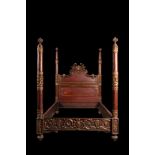 A crowned, painted and gilt carved wooden bed, 19th C.