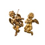 Two gilt wooden angels of which one plays a violin, 19th C.