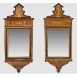 A pair of large French partly ebonised walnut mirrors with various woods inlaid, dated 1884