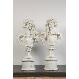 A pair of large white patinated wooden ornaments with a shield and flowers, 18th C