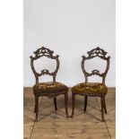 A pair of Black Forest wooden chairs with embroidered upholstery, ca. 1900