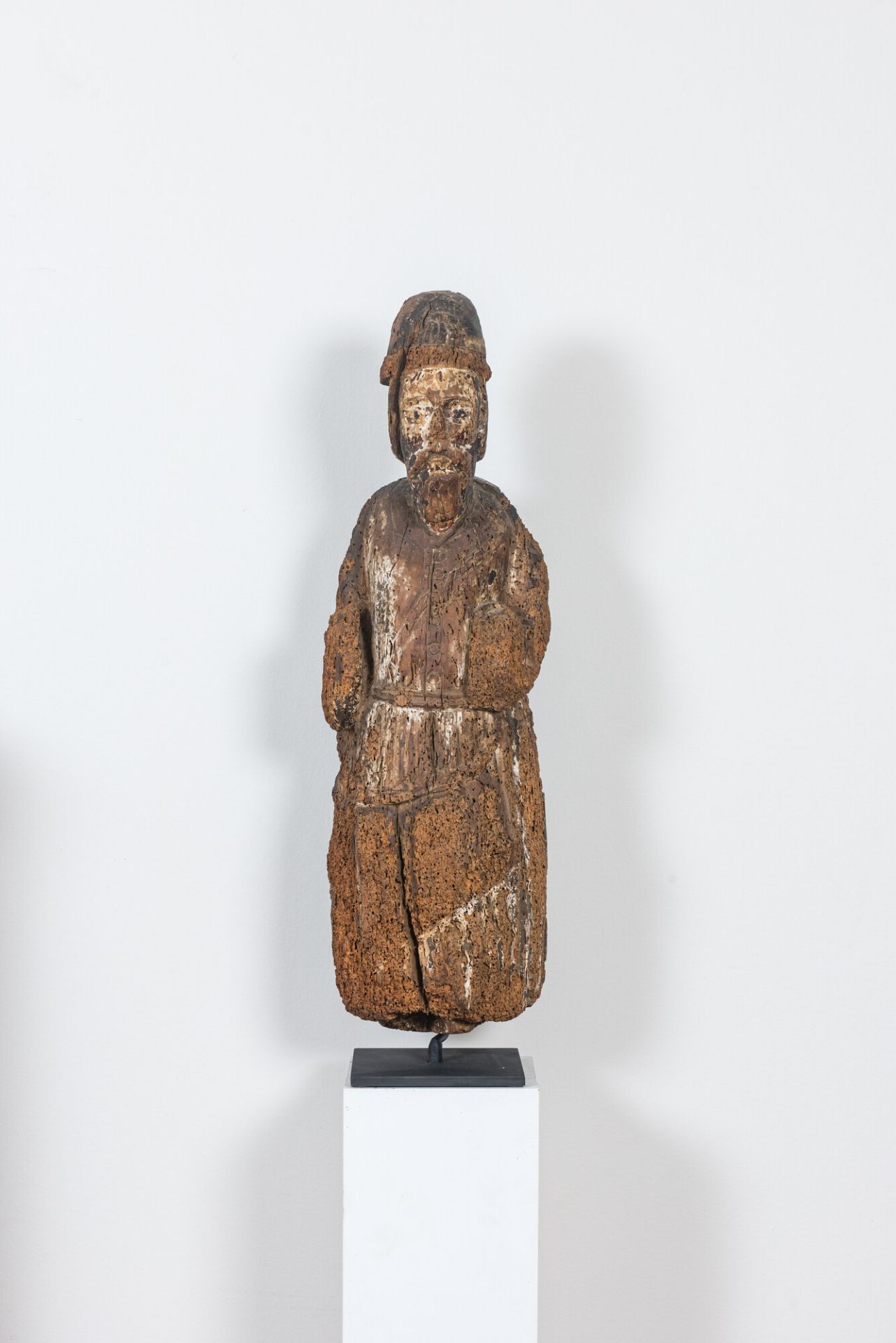 A Romanesque wooden figure of an apostle with traces of polychromy, probably Flanders, 14th C.