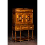 A cabinet on foot in various woods inlaid with faux tortoiseshell, 20th C.