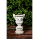 A white painted concrete garden urn on stand, 20th C.