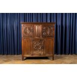 A Flemish oak three-door cupboard with carved panels, 16th C.