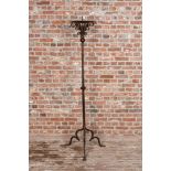 A large wrought iron candlestick, 19th C.