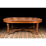 A large oval wooden table on carved baluster-shaped legs, early 20th C.