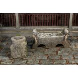 A carved stone double arch-shaped garden ornament and a bird bath, 19th and 20th C.