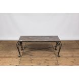 A wrought iron coffee table with marble top, 20th C.