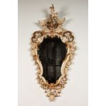 An Italian patinated and gilt wooden mirrors, 18/19th C.