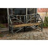 A garden bench in a patinated faux bois structure, 20th C.