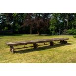 An impressive long wooden table with recesses from the dining room of an orphanage or monastery, 19t