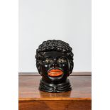 A lacquered terracotta 'blackamoor' tobacco jar, 20th C.