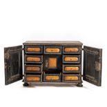 An ebonised and inlaid wooden cabinet, 19th C.