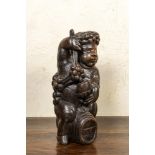 A carved walnut figure of Bacchus on a barrel, 18/19th C.