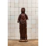A large polychromed carved wooden folk art figure of a female saint, North of France, probably 16th