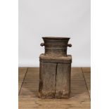 A large iron mortar on wooden stand, 17th C.