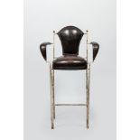 A decorative bar chair in leather and patinated metal, 20th C.
