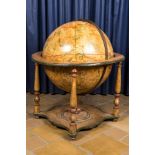 A celestial globe on a polychrome wooden base, 19th C.