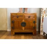 A Chinese two-door cabinet with two drawers, 20th C.