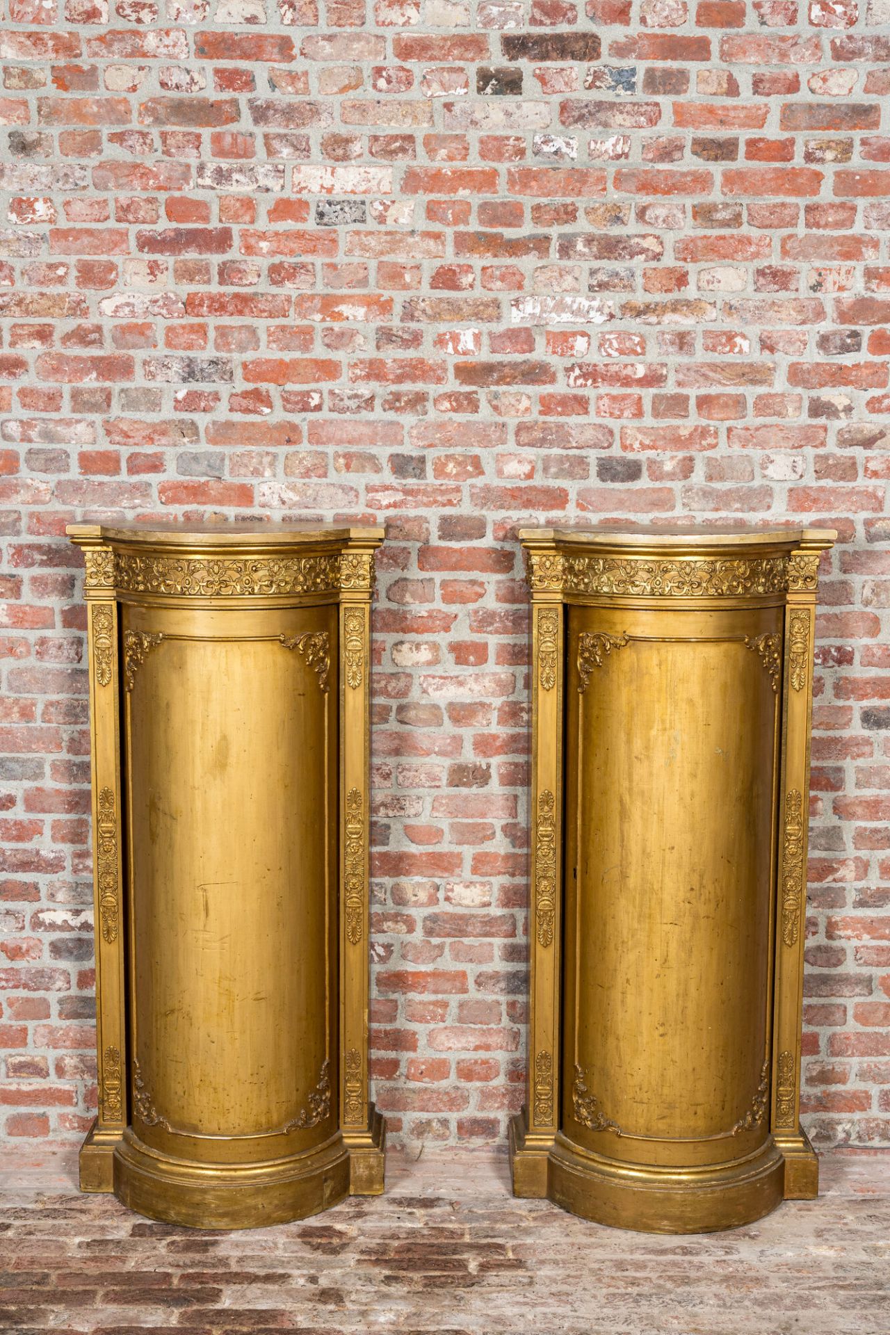 A pair of gilt wooden Empire style demi-lune cabinets, ca. 1900