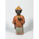 A French polychrome terracotta fireplace in the shape of a pipe smoking Moor, ca. 1900