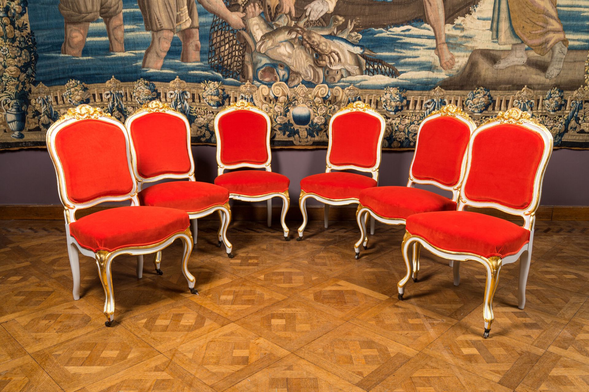 Six partly gilt wooden chairs with red velvet upholstery, 18/19th C.