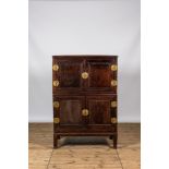 A Chinese four-door wooden brass mounted cabinet, 20th C.