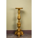 A large Italian gilt wooden pedestal with lion's feet, 19th C.