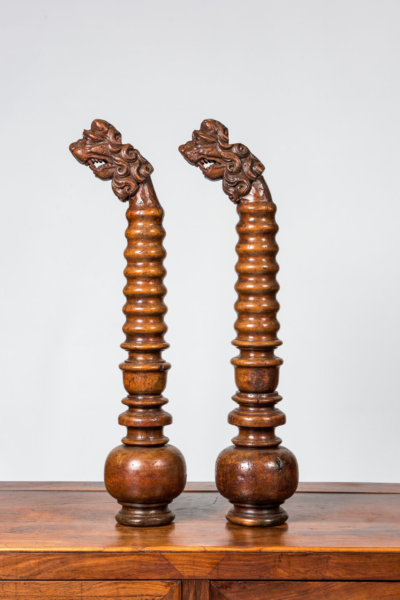 A pair of Italian baluster-shaped elements topped with lion's heads, 17/18th C. and later