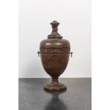 A patinated carved wooden urn and cover, probably France, 19th C.
