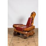 A fauteuil composed of tree trunk fragments with faux-crocodile leather upholstery, 20th C.