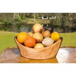 Fourteen painted marble and alabaster imitation models of fruits in a modern wooden bowl, 19/20th C.