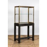 A French brass display cabinet on later wooden stand, 20th C.